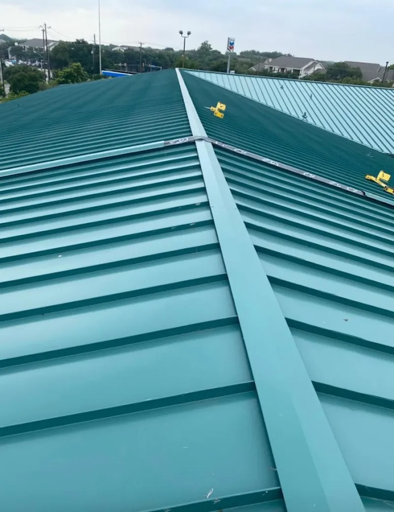Green commercial metal roof ridge and valley for Metal Roof Repair in Todd Creek