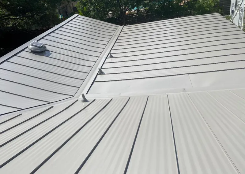 Solar attic fan installed on a metal roof for Roof Ventilation in Todd Creek